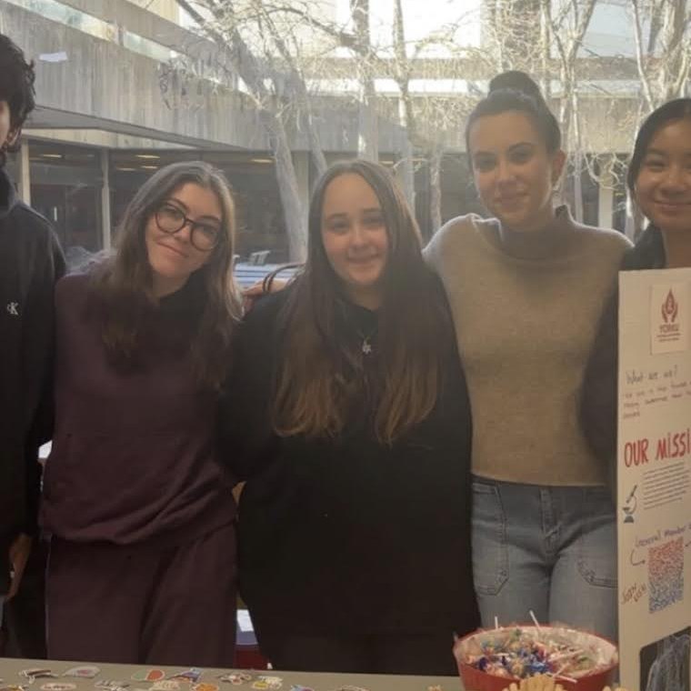 Students standing together at an awareness booth